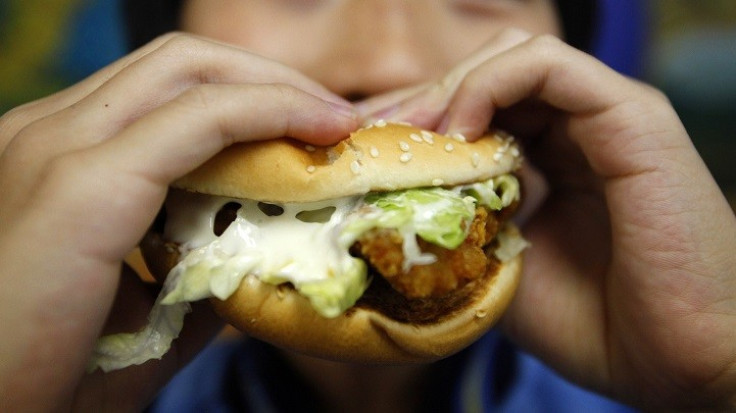 Sticky fingers: Child tucks in to chicken burger