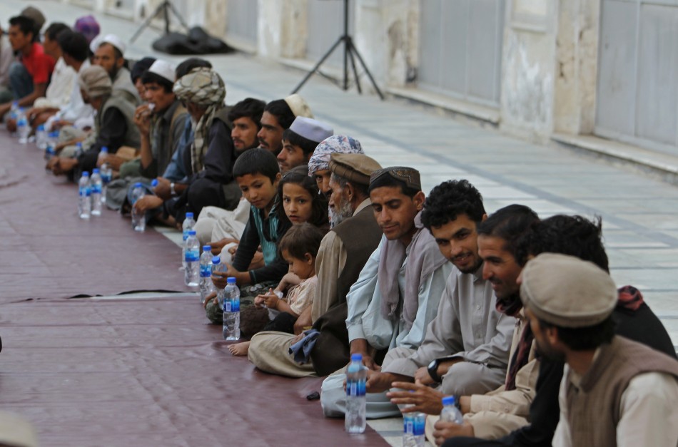 Afghan Muslims wait for their Iftar meal on the first day of Ramadan, the holiest month in the Islamic calendar, at a mosque in Kabul
