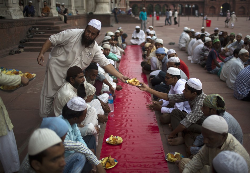 Muslims arrange plates before iftar breaking fast meal on the first day of the holy month of Ramadan in India