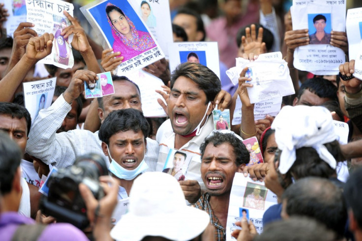 Relatives show pictures of garment workers, who are missing after the collapse of the Rana Plaza disaster (Photo: Reuters)