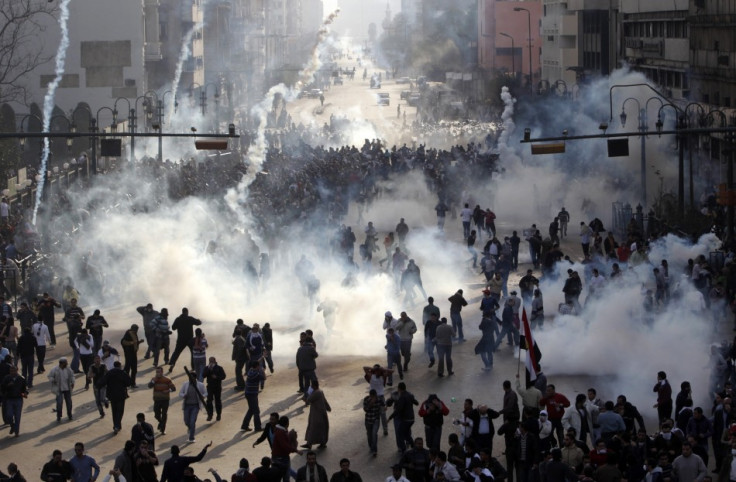 Protesters flee from tear gas fire during clashes in Cairo January 28, 2011 (Reuters)