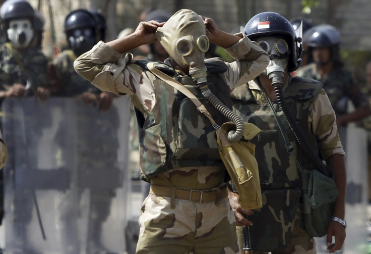 Army soldiers wear gas masks before clashes with members of the Muslim Brotherhood and supporters of Morsi (Reuters)