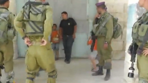 Wadi Maswadeh, 5, is detained by Israeli troops. Wadi Maswadeh, 5, is detained by Israeli troops.