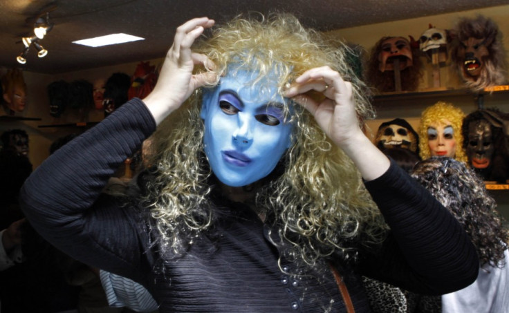 A woman tries on a mask from the film Avatar