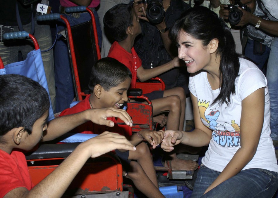 Kaif R speaks with disabled children who came for a special screening of her movie De Dana Dan at a multiplex in Mumbai December 4, 2009.