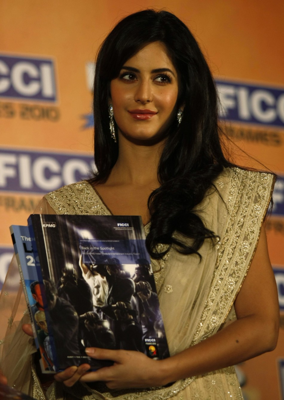 Kaif holds a yearbook during its release at the inauguration session of the 11th FICCI-FRAMES convention in Mumbai March 16, 2010.