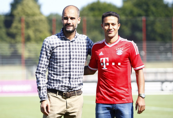 Pep Guardiola and Thiago Alcantara (R)