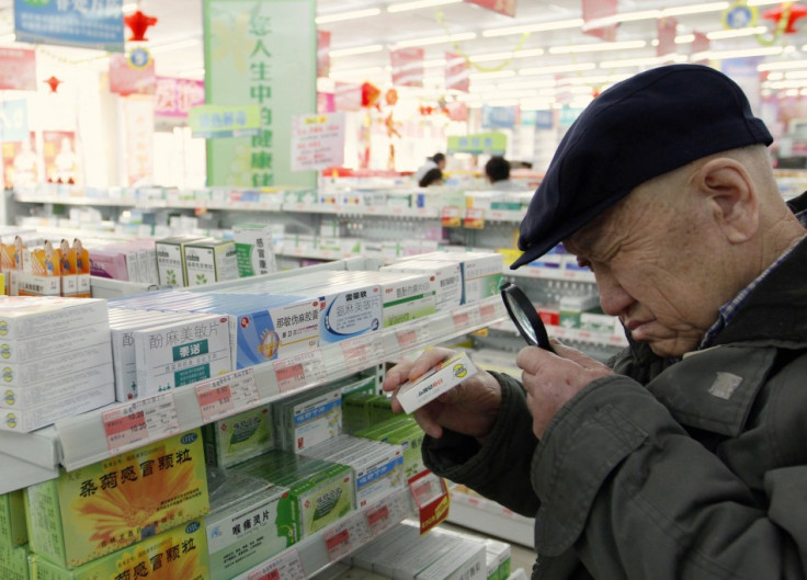 A customer casts a close eye over the product in a Chinese pharmacy
