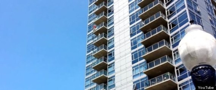A woman dangles from the 14th floor of The Mark condominium building in San Diego