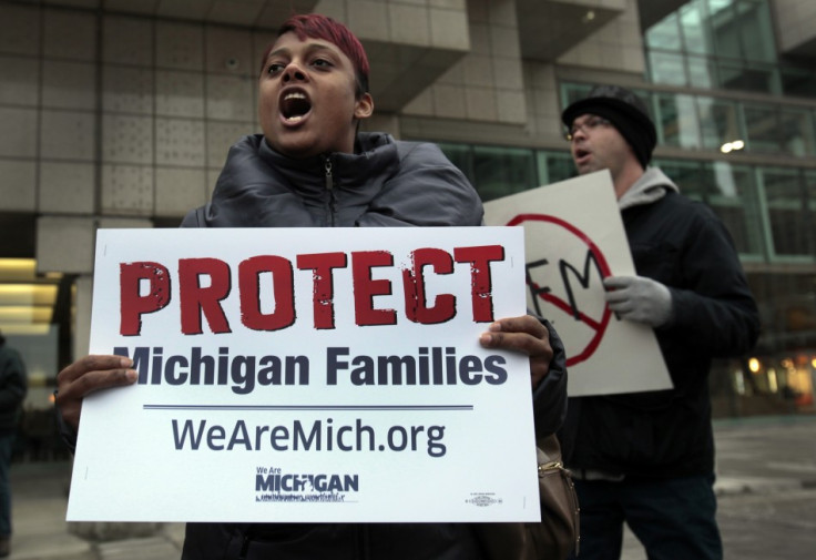 United Auto Workers Union member Dawn Bennett joins about 150 demonstrators to protest against Michigan Governor Rick Snyder.