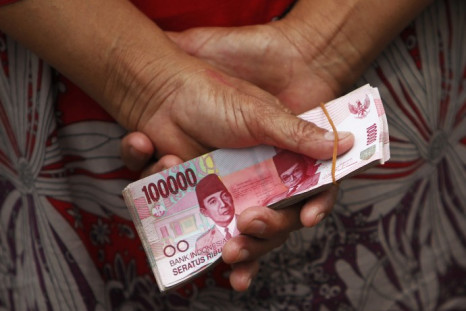 A woman holds Indonesian rupiah