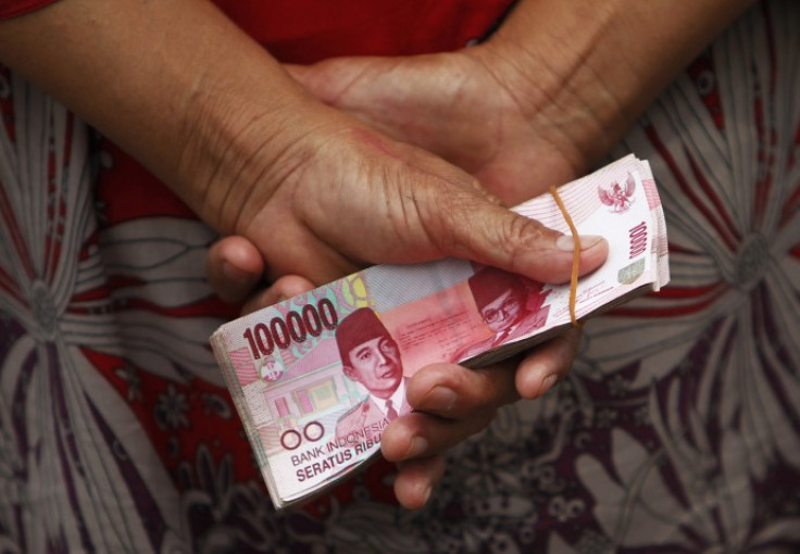 A woman holds Indonesian rupiah