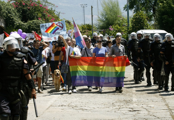 Riot police protect LGBT activist during the parade (Reuters)