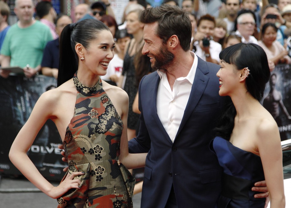 Actor Hugh Jackman poses with Tao Okamoto L and Rila Fukushima R at the UK Premiere of The Wolverine at Leicester Square in London