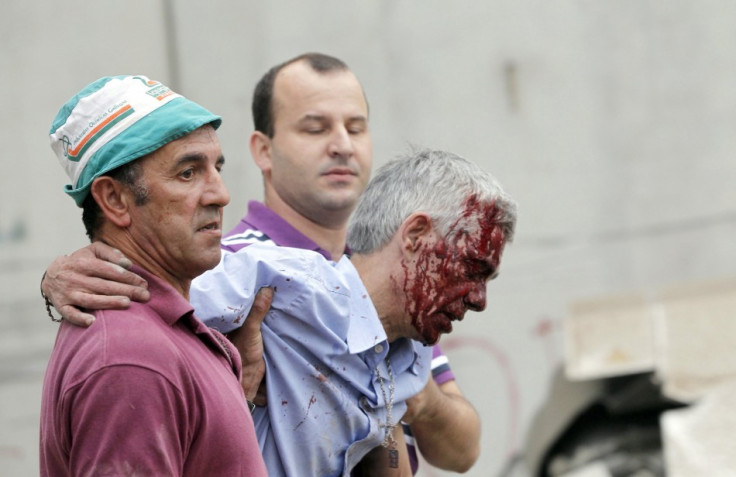 Francisco Jose Garzon Amo (centre )is supported by two men after Wednesday's crash