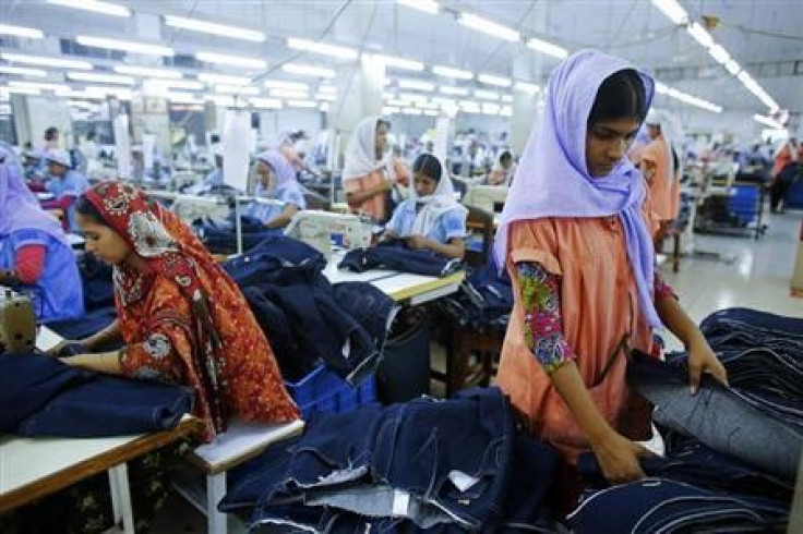 Workers sort clothes at a garment factory near the collapsed Rana Plaza building in Savar, Bangladesh June 16, 2013.