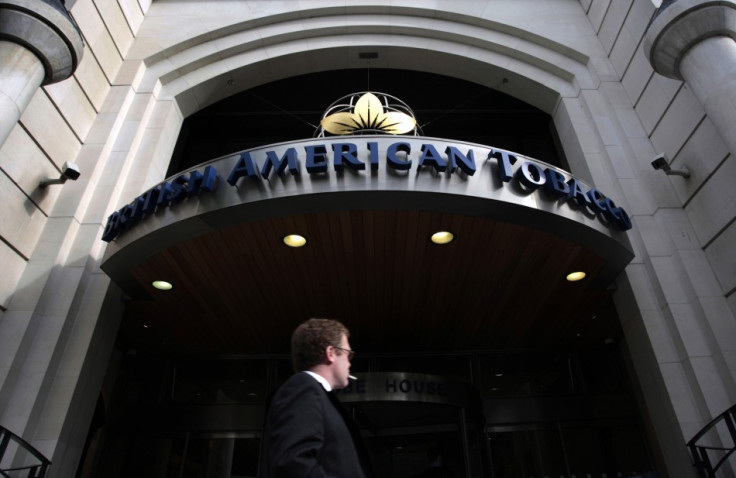 A man smokes as he passes the British American Tobacco offices in London.