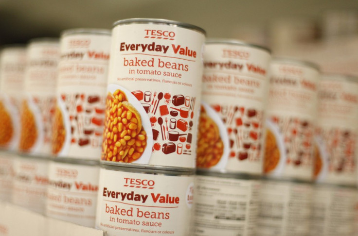Tesco Everyday Value baked beans are stacked on a shelf at a Tesco shop in Bishop's Stortford, southern England