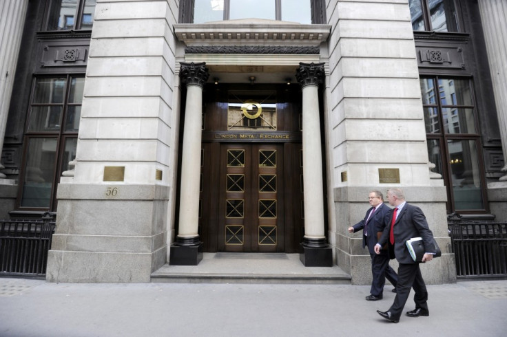 Men walk past the London Metal Exchange (LME) in London