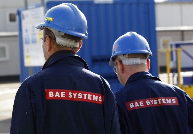 BAE Systems employees walk together at Roysth naval yard in Rosyth, Scotland.
