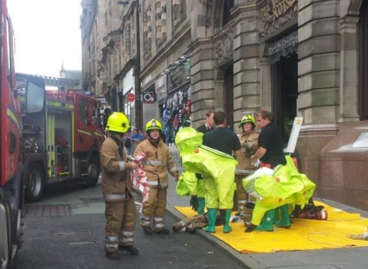 Fire-fighters wearing protective clothing outside Scotsman hotel