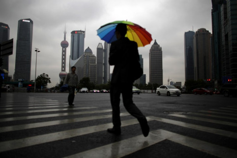 A businessman walks with an umbrella