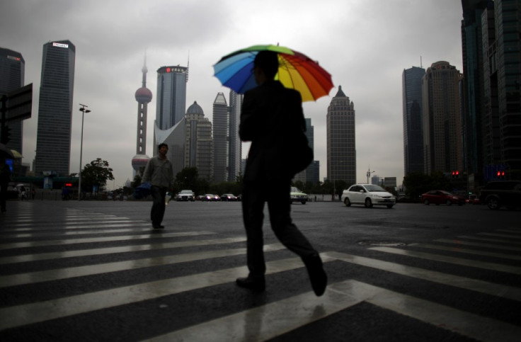 A businessman walks with an umbrella