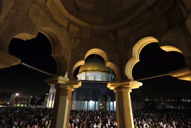 Palestinian worshipers pray in front of the Dome of the Rock, in the Al Aqsa Mosque compound in Jerusalem early August 4, 2013, during Lailat-Al-Qadr, or Night of Power, in which the Muslim holy book of Quran was revealed to Prophet Mohammad by Allah. (Ph