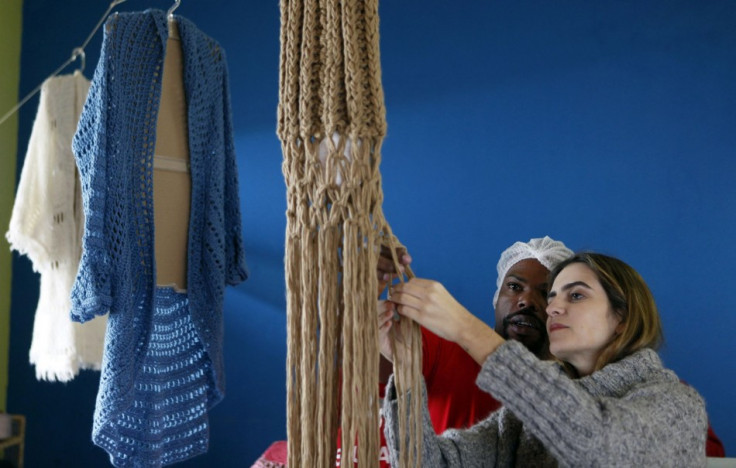 Guimaraes supervises a prisoner knitting for her in the Arisvaldo de Campos Pires prison in Brazil. (Photo: REUTERS/Paulo Whitaker)