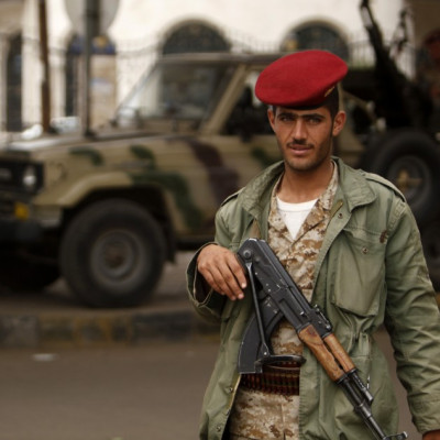 An army trooper looks on, while manning a checkpoint in Sanaa