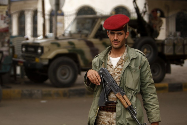 An army trooper looks on, while manning a checkpoint in Sanaa