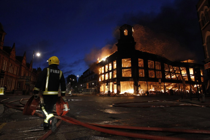 A firefighter walks past a burning building in Tottenham, north London August 7, 2011 (Photo: Reuters)