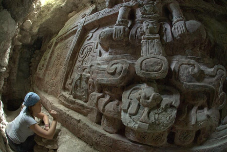 Archaeologist Anya Shetler cleans inscriptions on a Mayan Frieze unearthed in Holmul, Guatemala. The frieze is said to be the most spectacular frieze ever found in the region. (Photo: Estrada-Belli/© Holmul Archaeological Project)