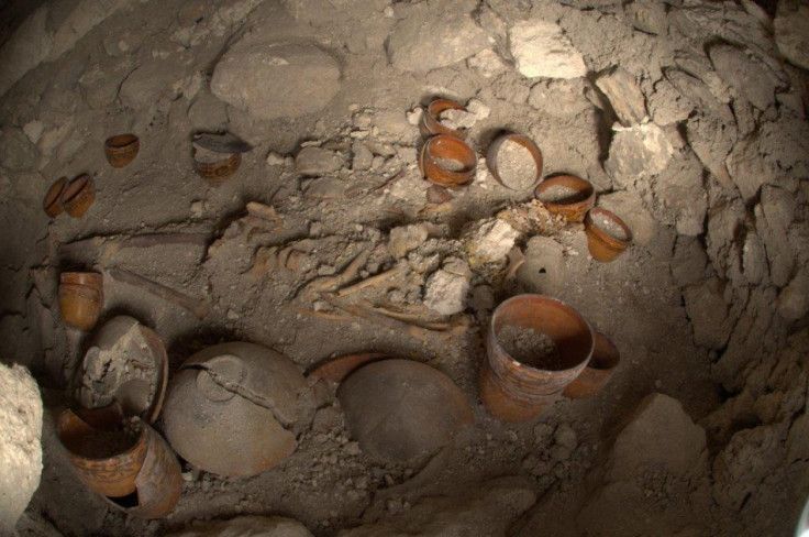 View of the tomb of a ruler at the time of its discovery in Holmul. There are 28 decorated vessels along with the dead body. Excavation for finding the identity of the skeleton led archaeologists to the massive frieze. (Photo: Jesus Lopez/MCD)