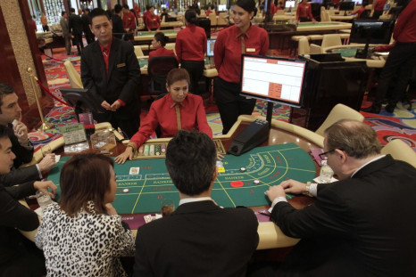 Foreigners play on a baccarat table during the opening of Solaire Casino-Resort in Pasay city.