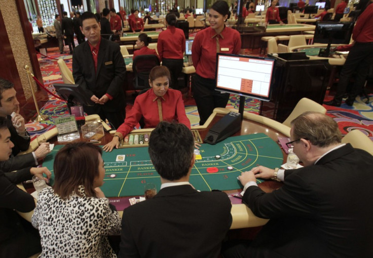 Foreigners play on a baccarat table during the opening of Solaire Casino-Resort in Pasay city.