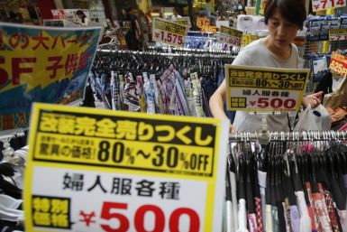 A woman looks at clothes at a local shopping street in Tokyo