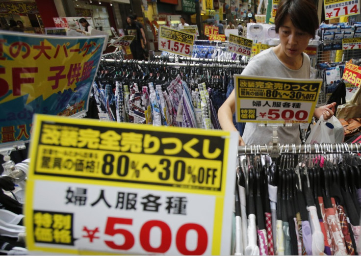 A woman looks at clothes at a local shopping street in Tokyo