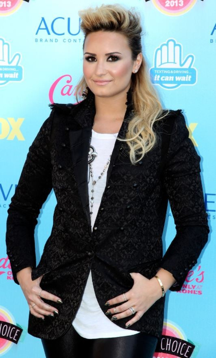 Singer Demi Lovato poses as she arrives at the Teen Choice Awards at the Gibson amphitheatre in Universal City, California August 11, 2013.