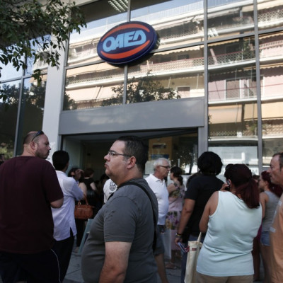 People wait outside a Greek Manpower Employment Organisation (OAED) office at Kalithea suburb in Athens.