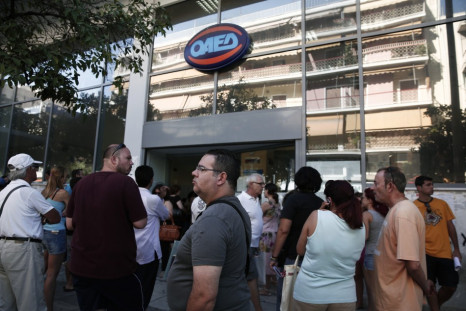 People wait outside a Greek Manpower Employment Organisation (OAED) office at Kalithea suburb in Athens.