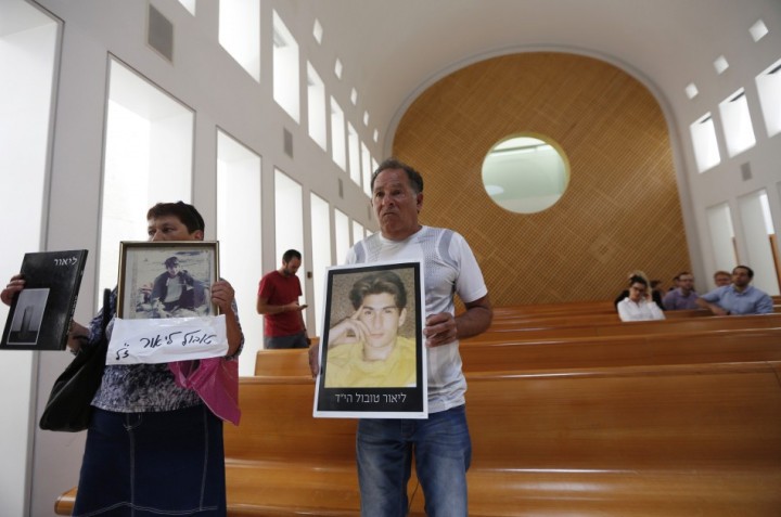 Miriam and Yaakov Tubol, parents of Lior, hold pictures of their son who was killed in 1990 by Palestinians, during a protest against the release of Palestinian prisoners Miriam and Yaakov Tubol, parents of Lior, hold pictures of their son who was killed in 1990 by Palestinians, during a protest against the release of Palestinian prisoners