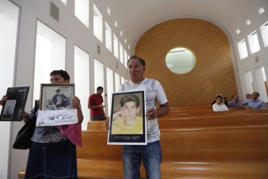 Miriam and Yaakov Tubol, parents of Lior, hold pictures of their son who was killed in 1990 by Palestinians, during a protest against the release of Palestinian prisoners