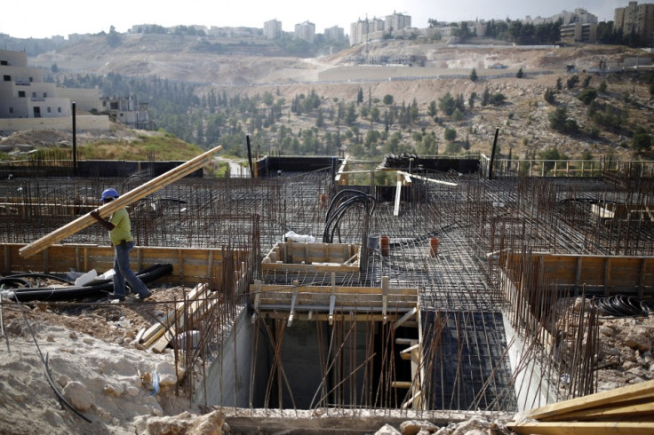 A labourer works on a construction site in Pisgat Zeev, an urban settlement in an area Israel annexed to Jerusalem