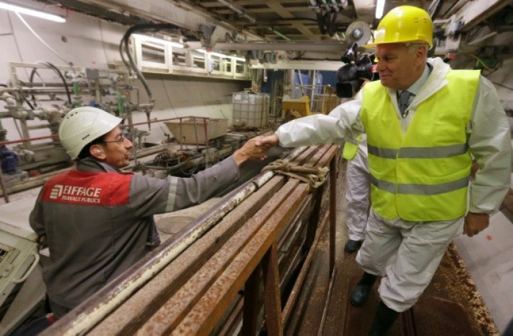 French Prime Minister Jean-Marc Ayrault (R) shakes hands with an employee of Eiffage TP during a visit of a tunnel digging site in Velizy-Villacoublay, near Paris (Photo: Reuters)