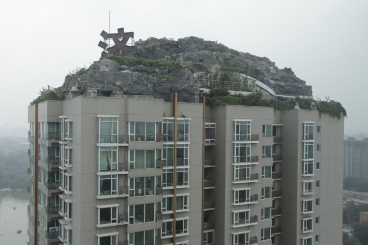 A privately built villa, surrounded by imitation rocks, on the rooftop of a 26-storey residential block in Beijing has sparked concerns over safety of the residents. (Photo: Reuters)