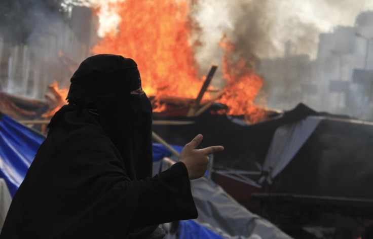 A member of the Muslim Brotherhood and supporter of deposed Egyptian President Mohamed Mursi shouts slogans as riot police clear Rabaa Adawiya square