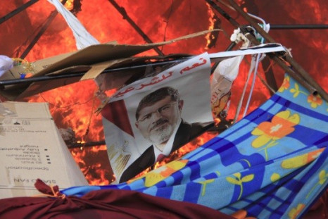 A poster of Mursi reads "Yes to legitimacy." as riot police clear the area of members of the Muslim Brotherhood and supporters of deposed Egyptian President Mohamed Morsi (Photo: Reuters)