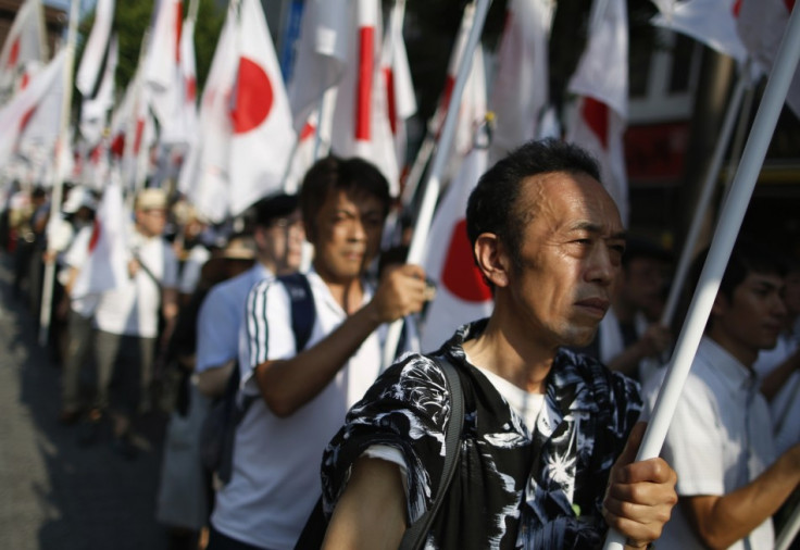 Nationalist Ganbare Nippon members march with Japanese flags in tribute at Yasukuni Shrine in Tokyo