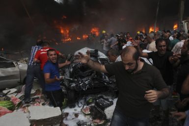 People shout for help at the site of an explosion in Beirut's southern suburbs,